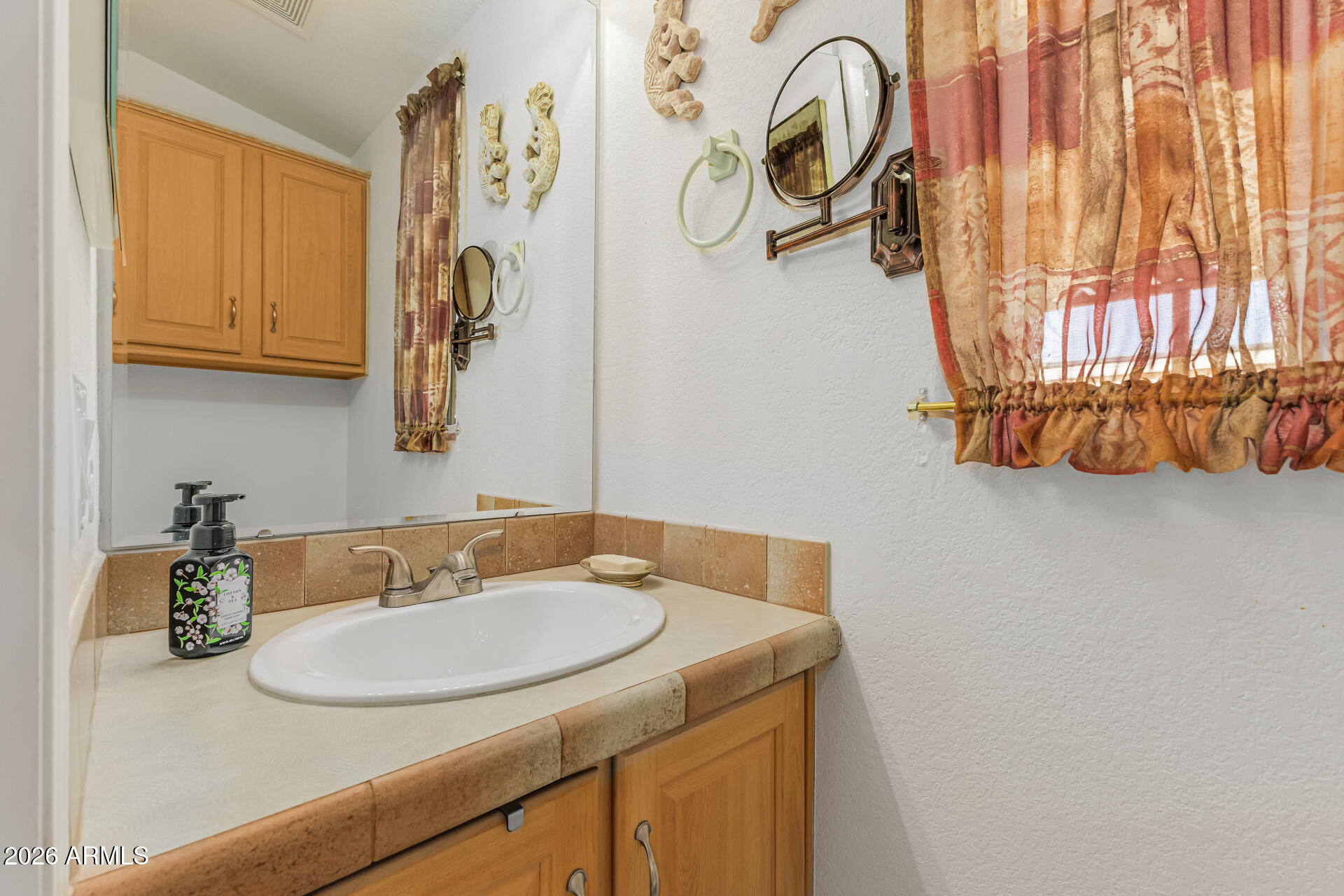 9302 East Broadway Road, Unit 186 Mesa, AZ 85208 - Photo 24 of 40 a bathroom with a sink and a mirror