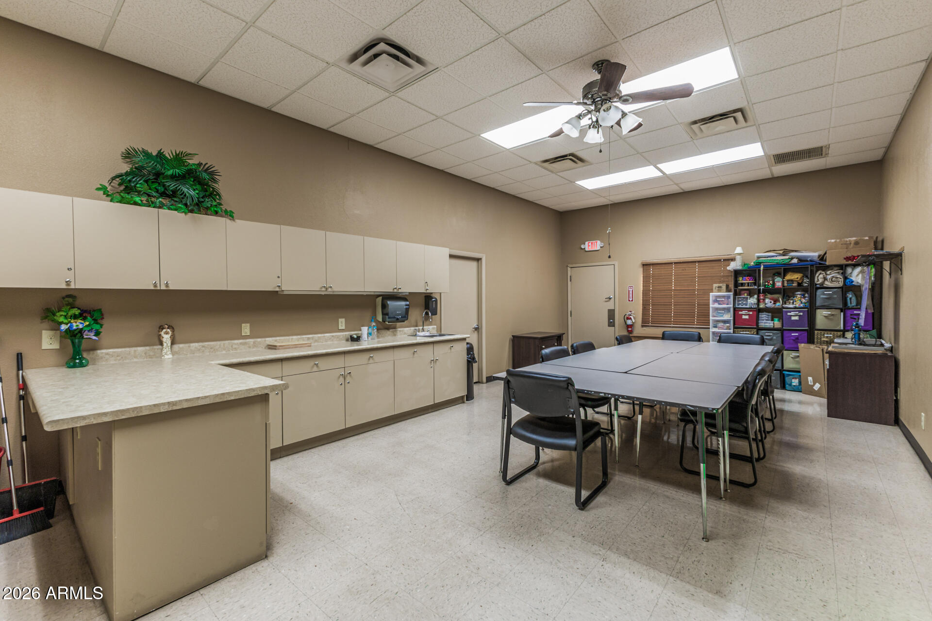 9302 East Broadway Road, Unit 186 Mesa, AZ 85208 - Photo 39 of 40 a kitchen with a table chairs stove and cabinets