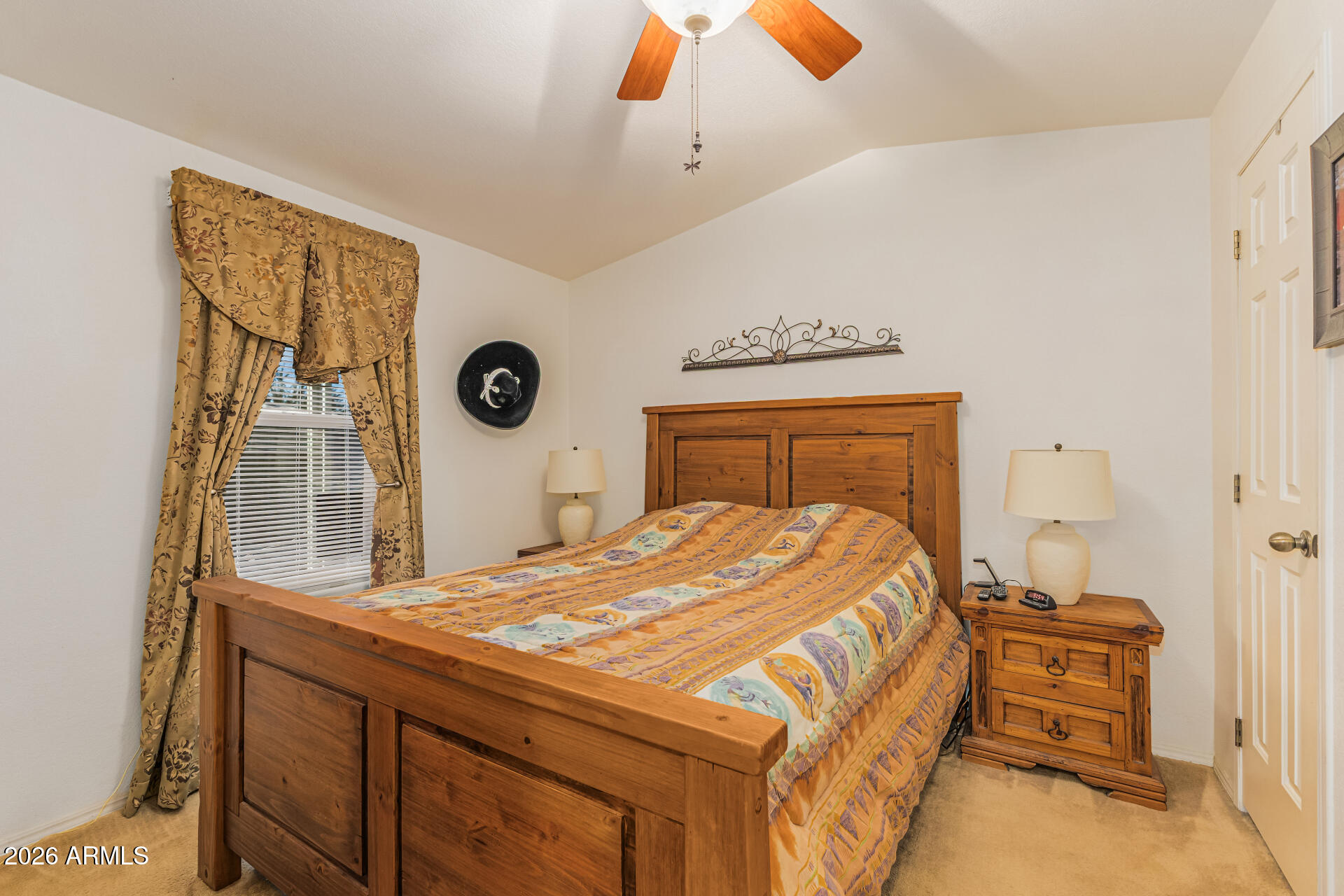 9302 East Broadway Road, Unit 186 Mesa, AZ 85208 - Photo 6 of 40 a bedroom with a bed and a chandelier