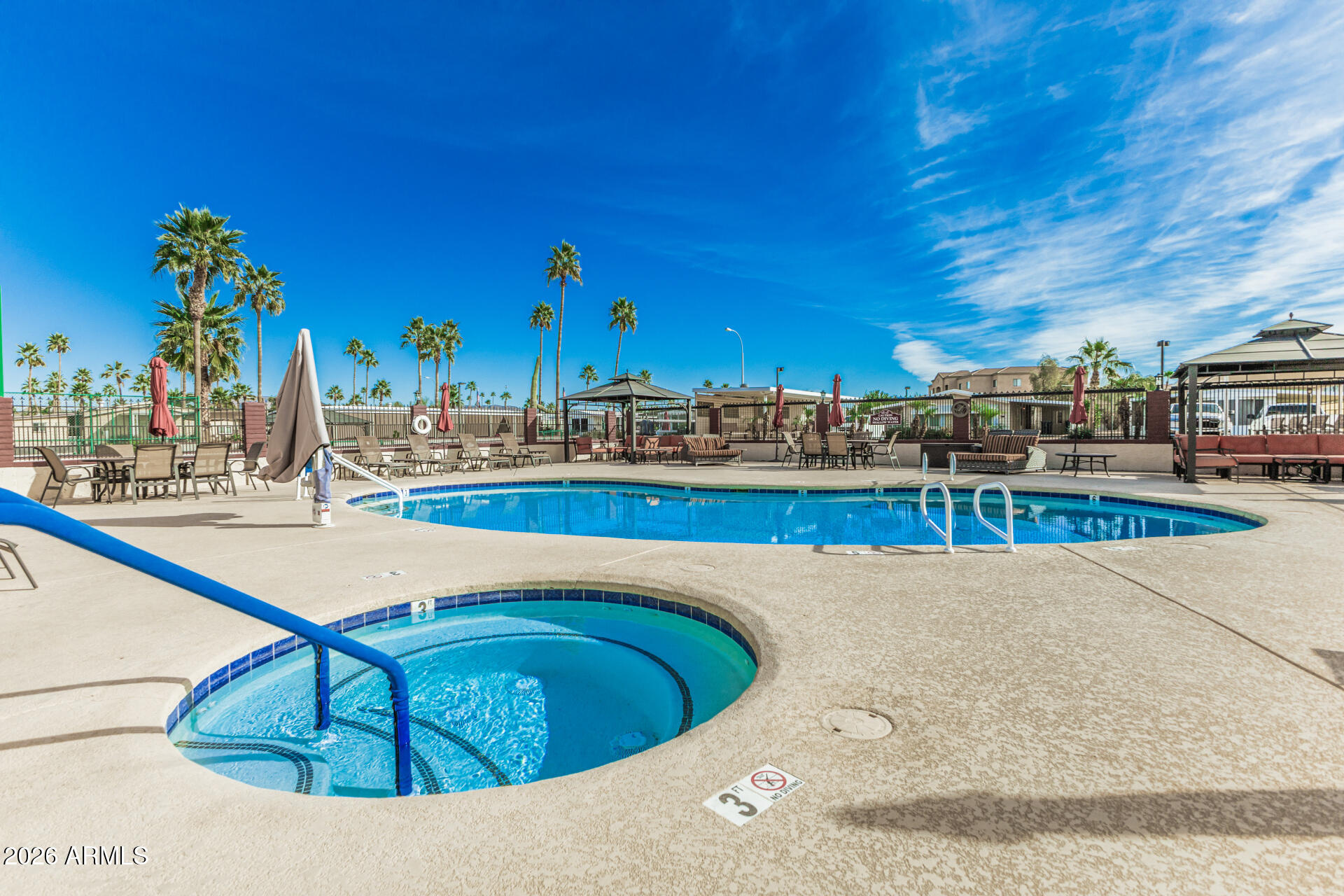 9302 East Broadway Road, Unit 186 Mesa, AZ 85208 - Photo 7 of 40 a view of a swimming pool with outdoor seating