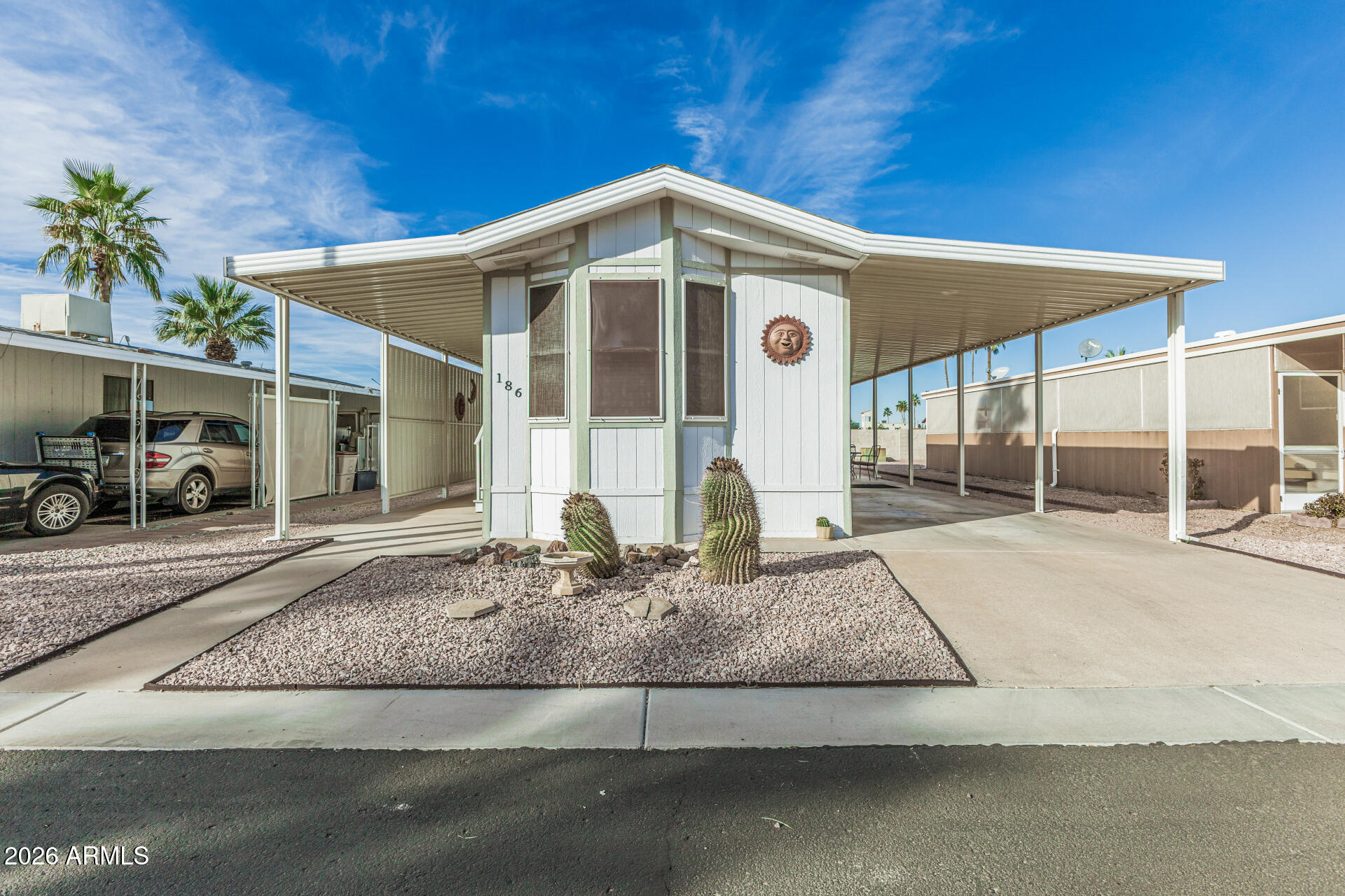 9302 East Broadway Road, Unit 186 Mesa, AZ 85208 - Photo 10 of 40 a front view of a house with garden