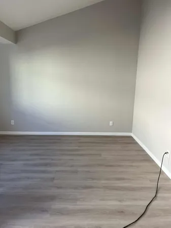 a room with an empty space and wooden floor