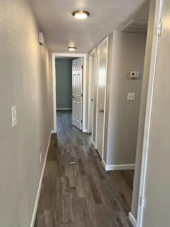 a view of hallway with wooden floor