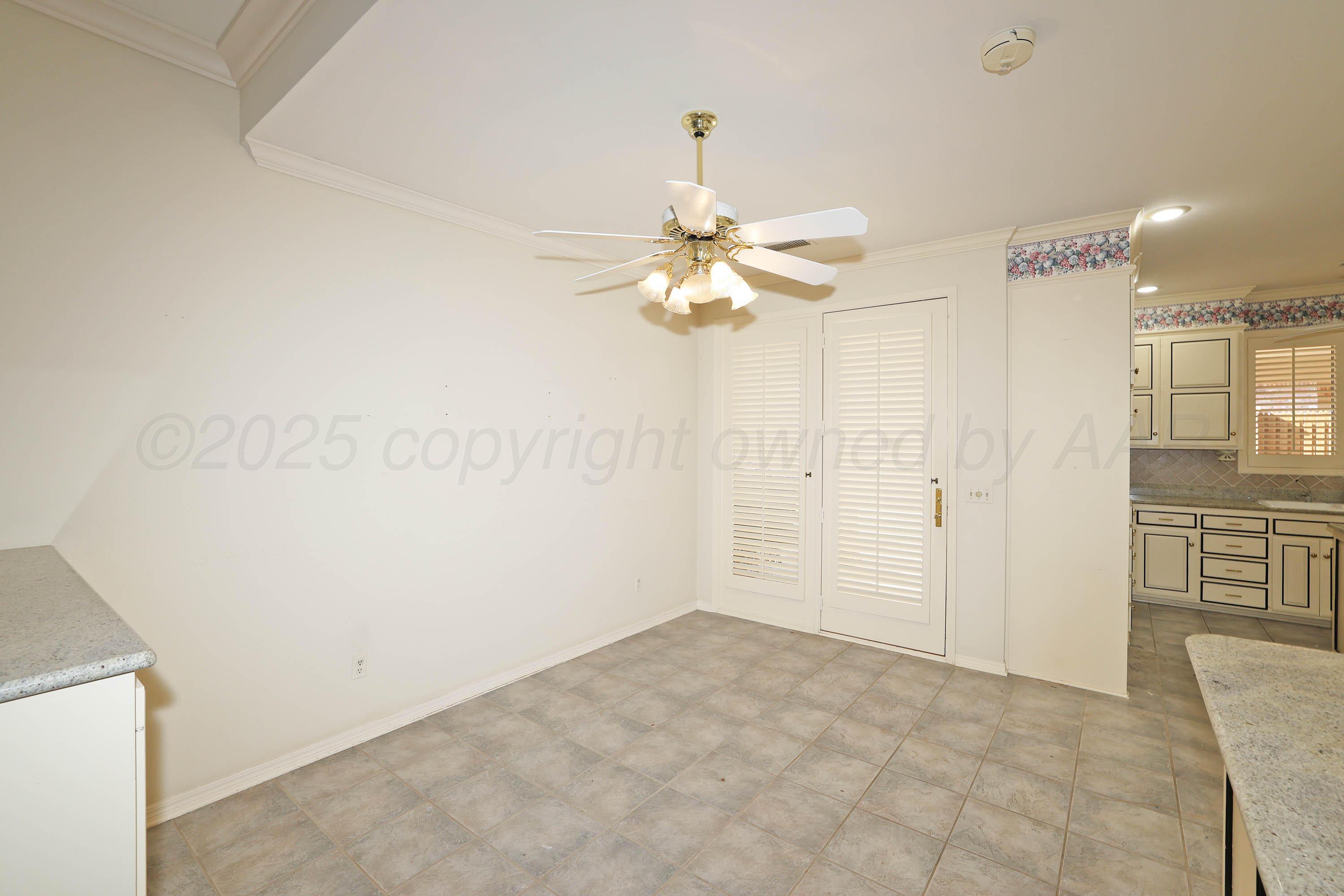 7707 Bent Tree Drive Amarillo, TX 79121 - Photo 11 of 47 a view of a livingroom with a chandelier fan and kitchen view