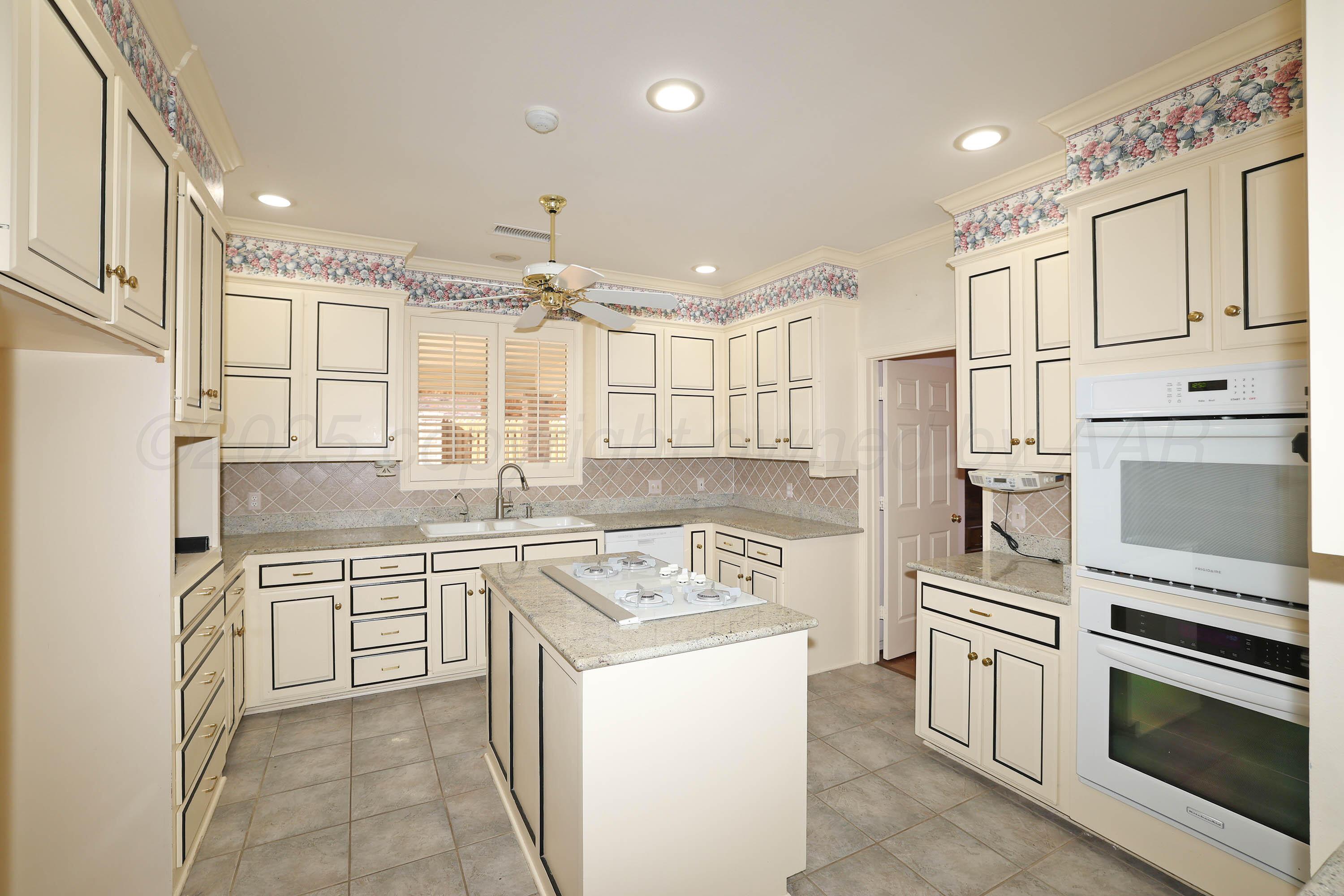 7707 Bent Tree Drive Amarillo, TX 79121 - Photo 13 of 47 a kitchen with a sink stove and oven