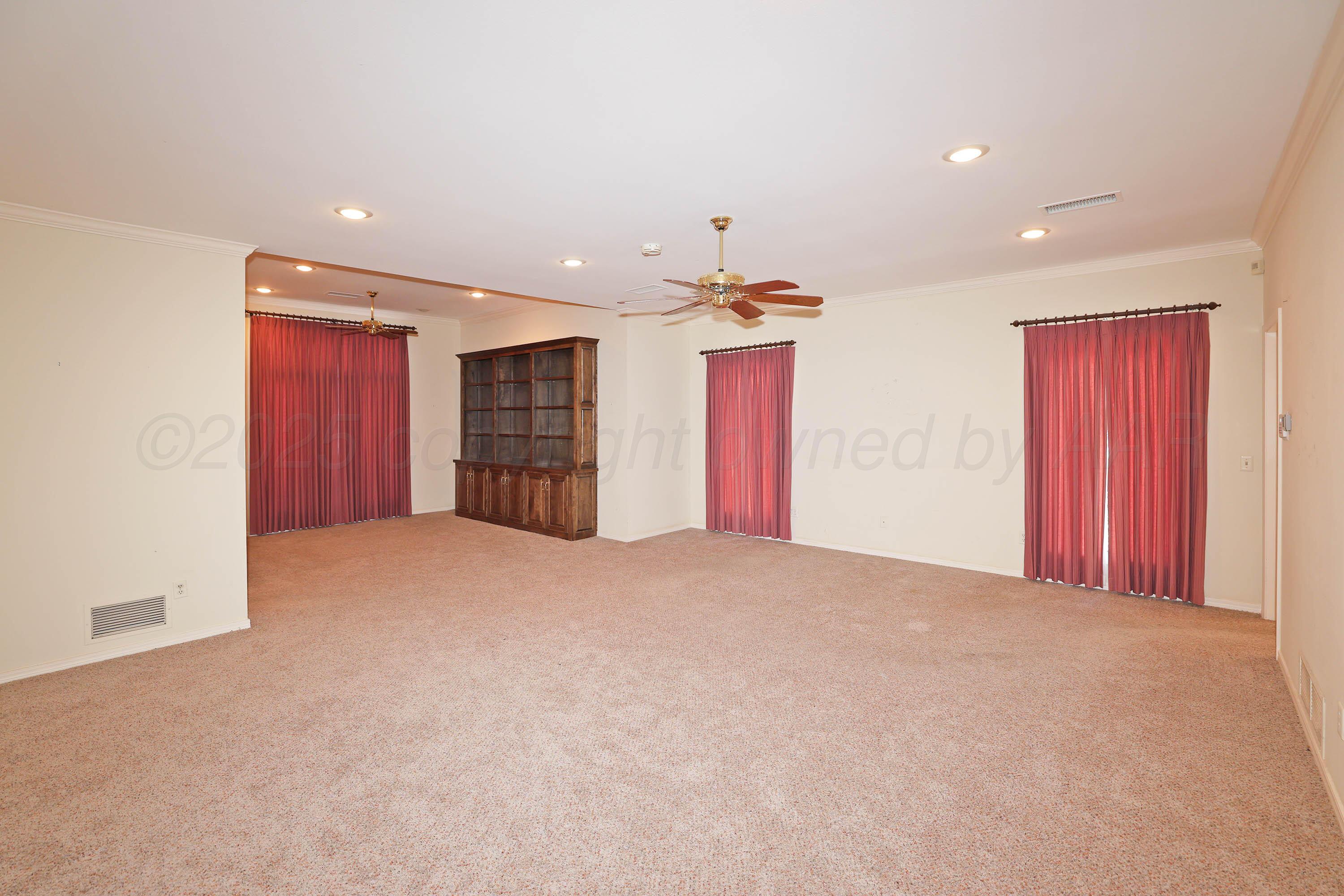 7707 Bent Tree Drive Amarillo, TX 79121 - Photo 18 of 47 a view of an empty room with a cabinet and a window