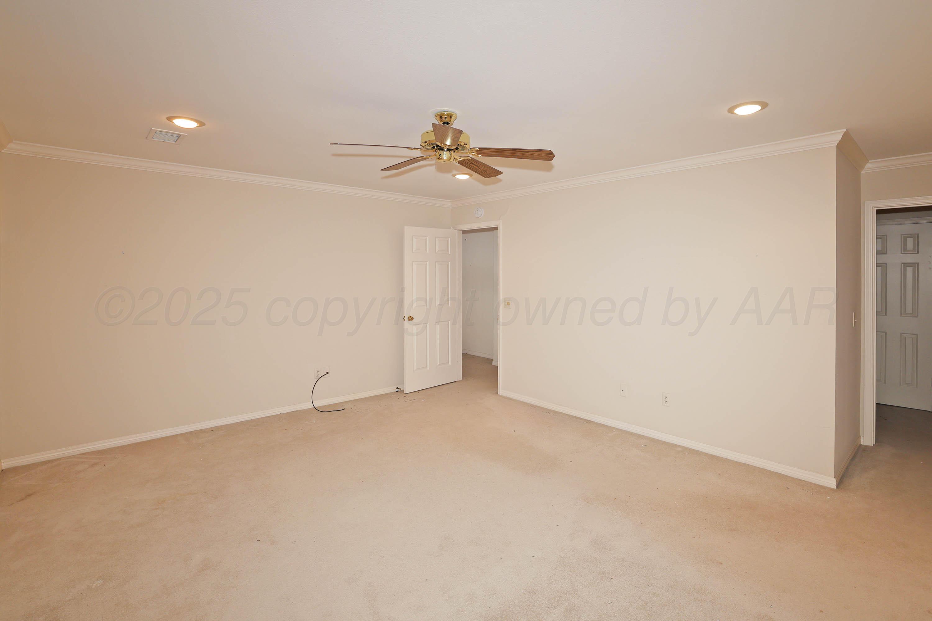 7707 Bent Tree Drive Amarillo, TX 79121 - Photo 27 of 47 an empty room with a ceiling fan and a window
