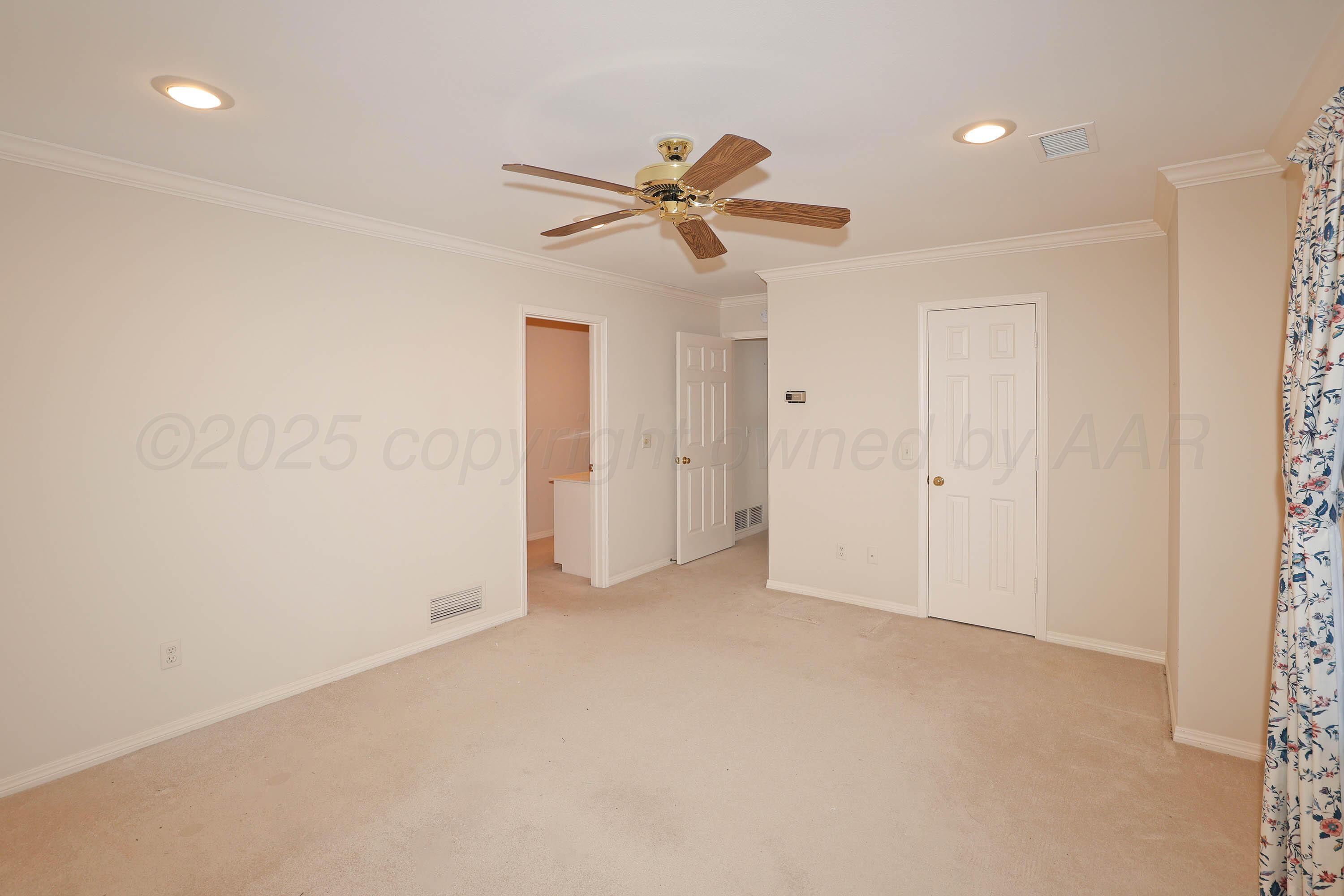 7707 Bent Tree Drive Amarillo, TX 79121 - Photo 31 of 47 an empty room with closet and fan