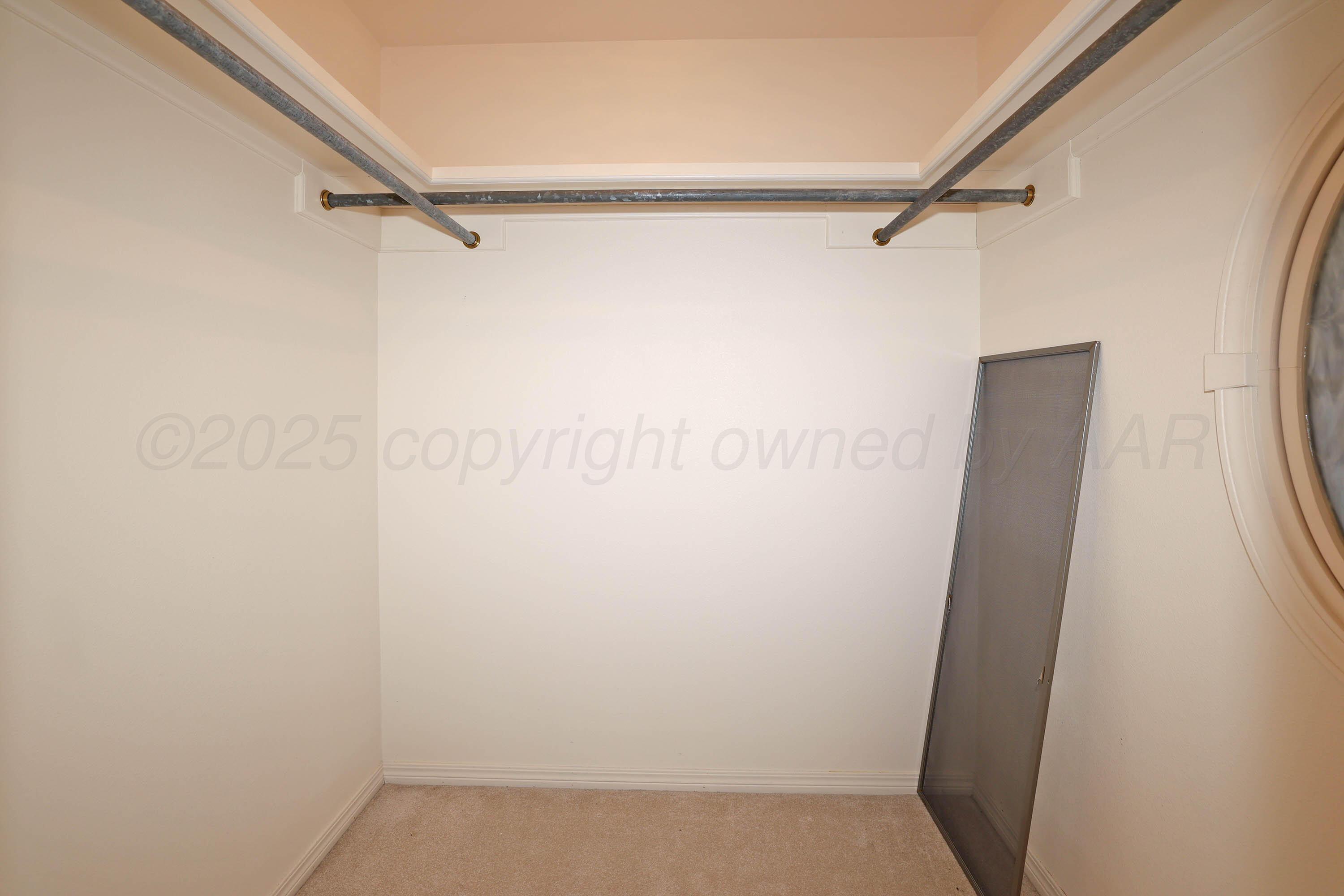 7707 Bent Tree Drive Amarillo, TX 79121 - Photo 33 of 47 a view of walk in closet with empty racks