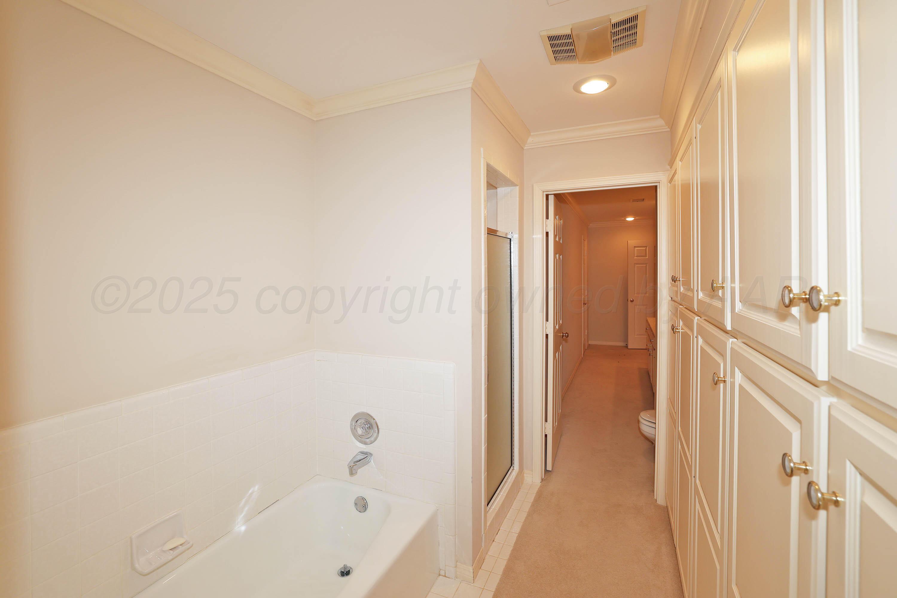7707 Bent Tree Drive Amarillo, TX 79121 - Photo 34 of 47 a bathroom with a bathtub and a shower