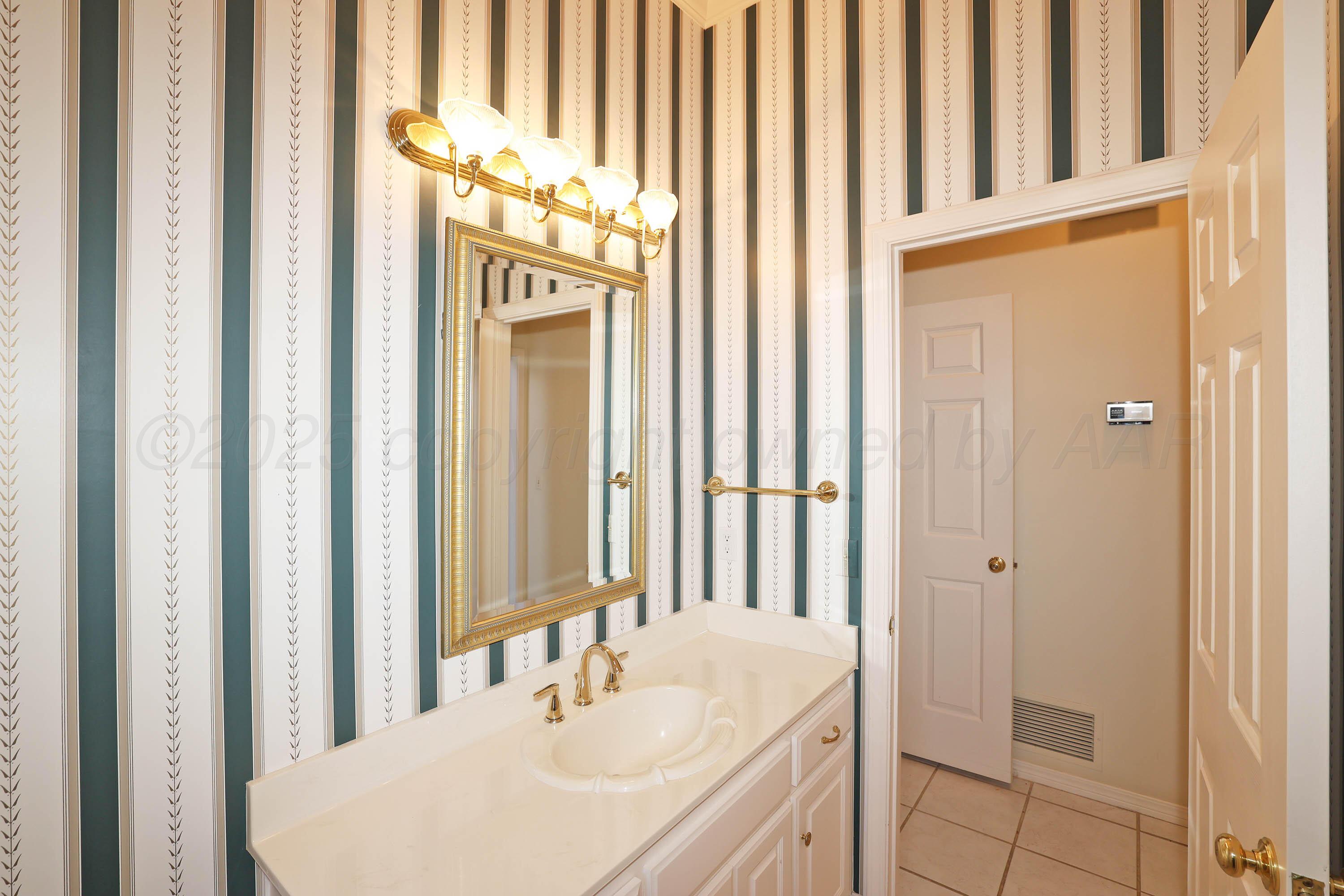 7707 Bent Tree Drive Amarillo, TX 79121 - Photo 37 of 47 a bathroom with a sink and a mirror
