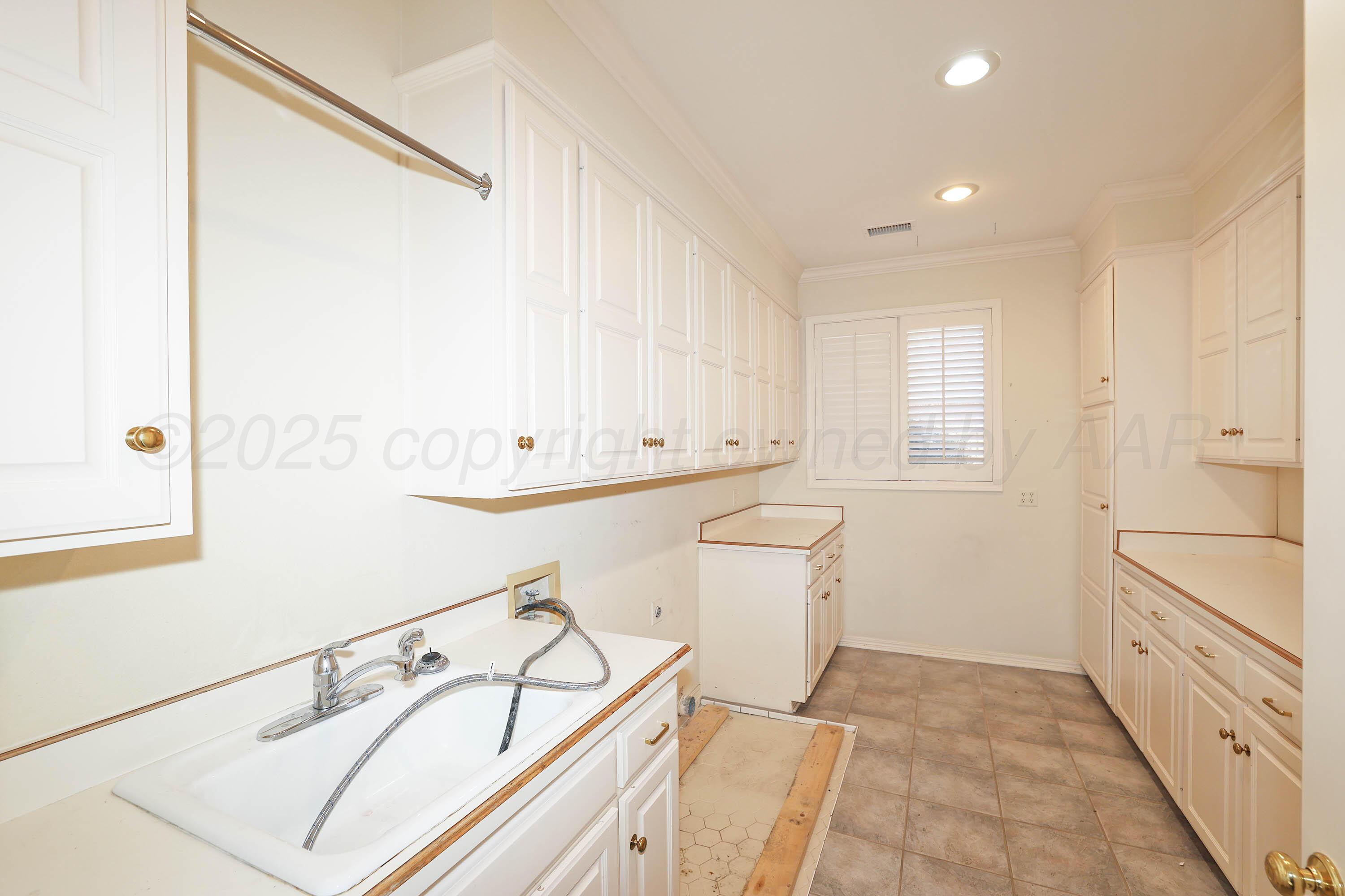 7707 Bent Tree Drive Amarillo, TX 79121 - Photo 38 of 47 a view of a hallway with white cabinets