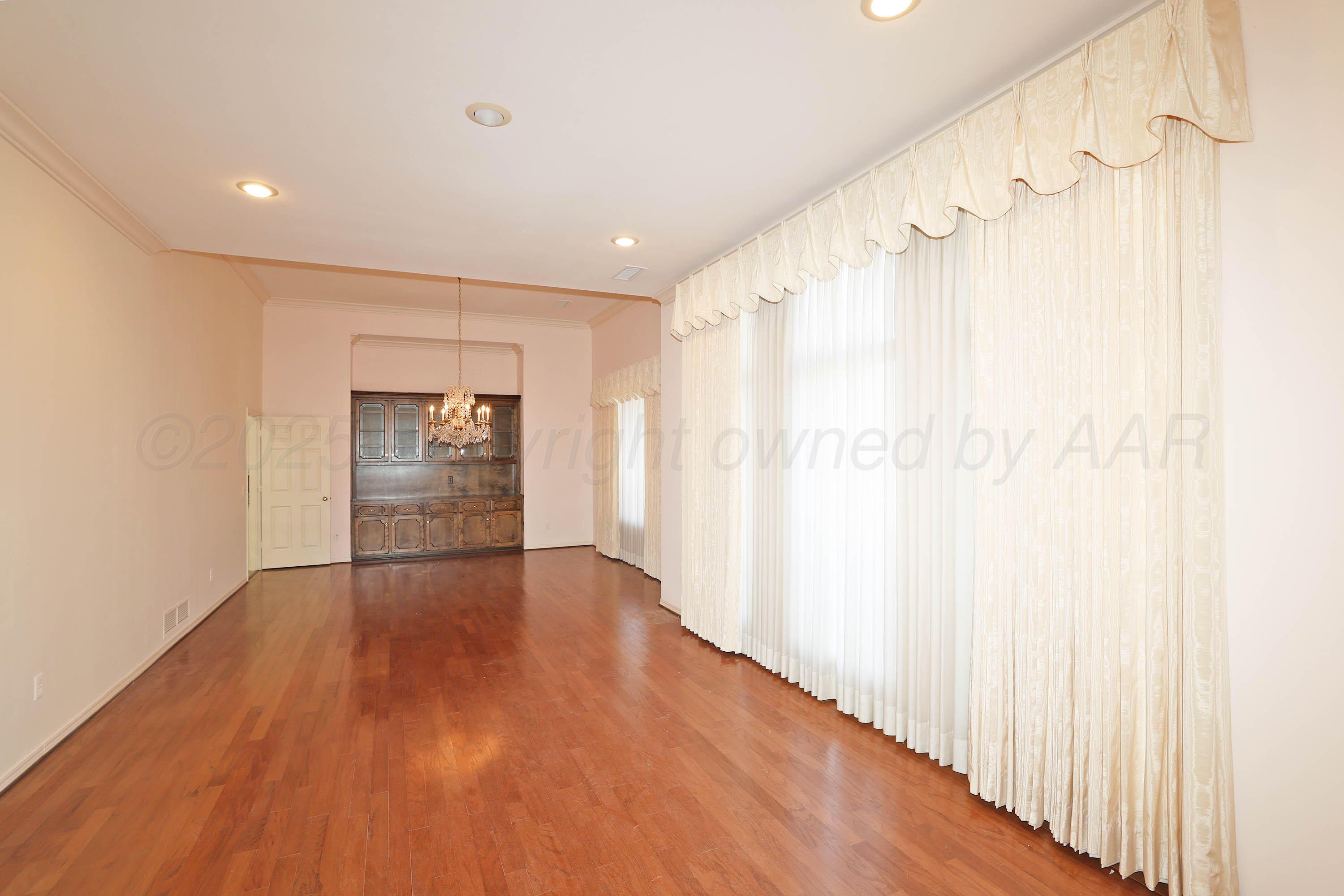 7707 Bent Tree Drive Amarillo, TX 79121 - Photo 5 of 47 a view of an empty room and wooden floor