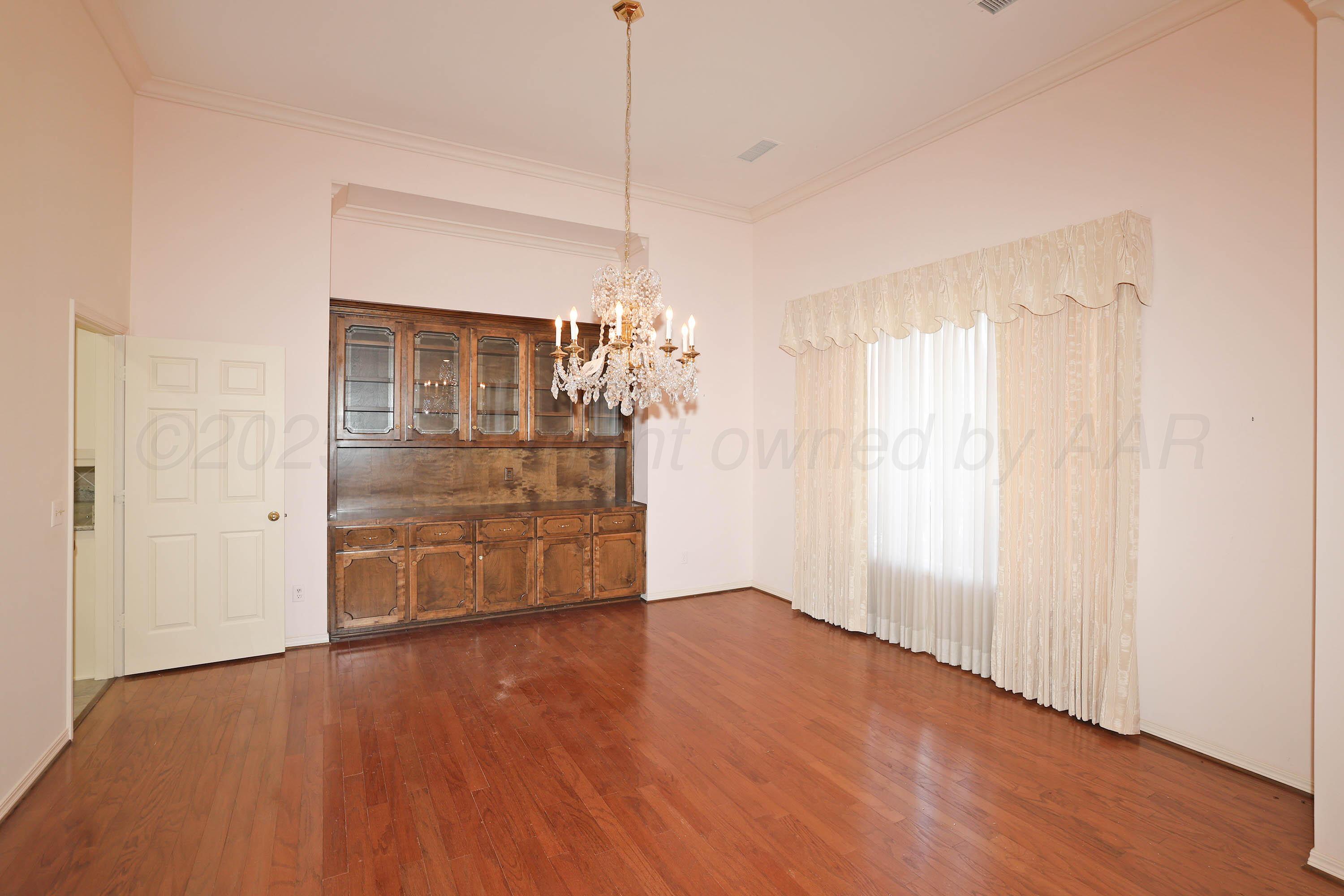 7707 Bent Tree Drive Amarillo, TX 79121 - Photo 6 of 47 a big room with chandelier fan and windows