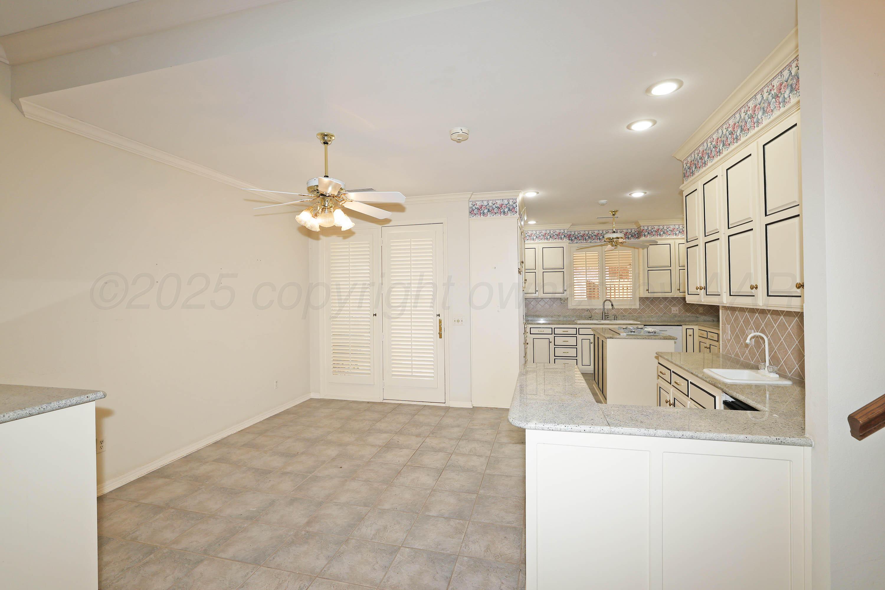 7707 Bent Tree Drive Amarillo, TX 79121 - Photo 10 of 47 a view of a kitchen with a sink and cabinet