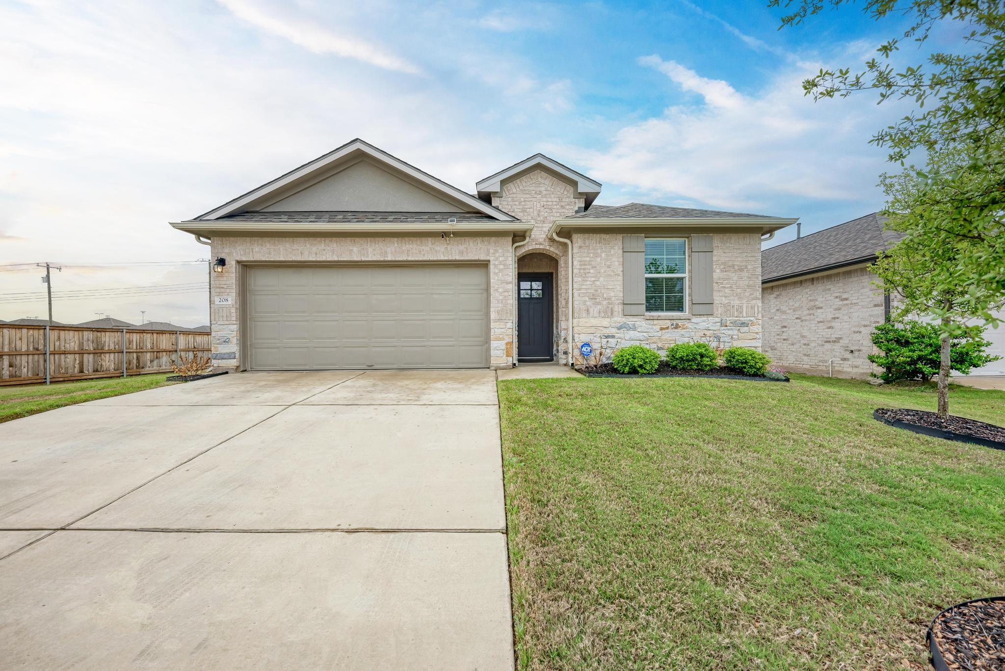 a front view of a house with garage