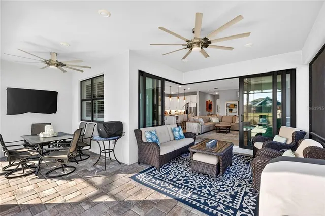 a view of swimming pool with a table and chairs under an umbrella