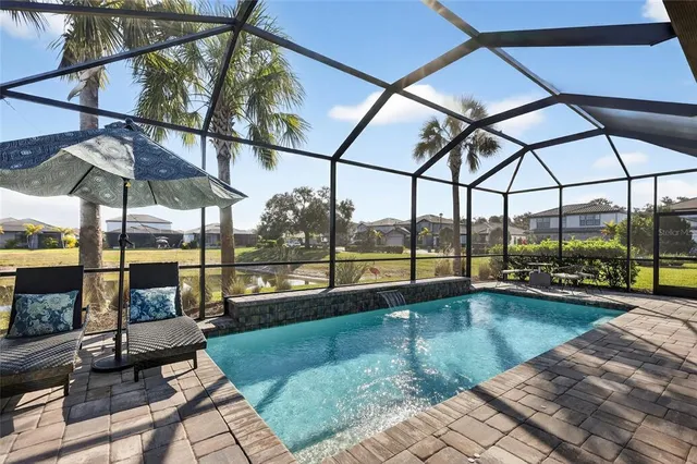a living room with furniture and view of kitchen