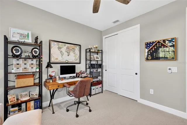 a view of a patio with a table and chairs under an umbrella