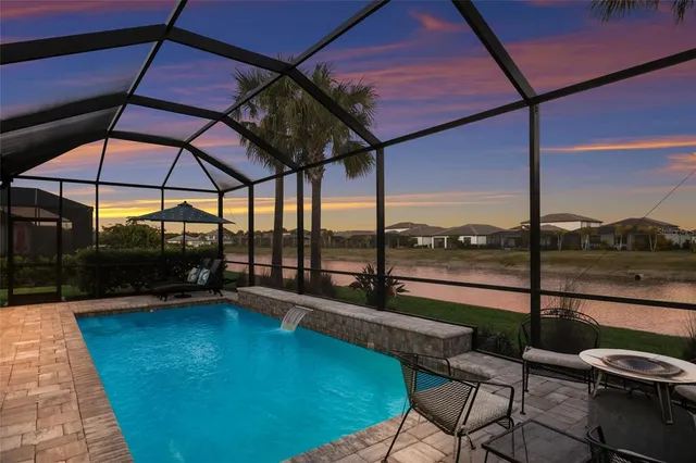 an aerial view of residential houses with outdoor space and swimming pool