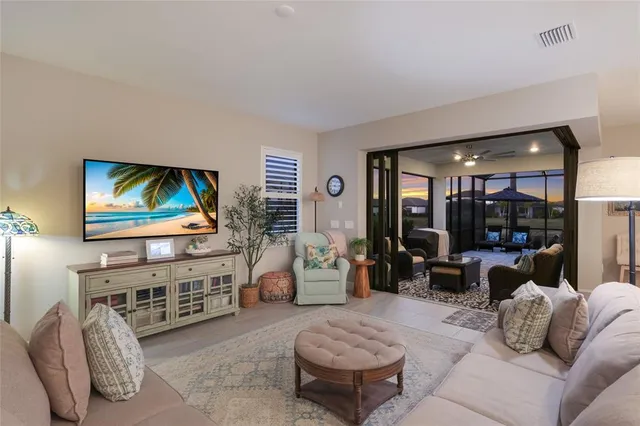 a kitchen with a sink a counter space and living room view