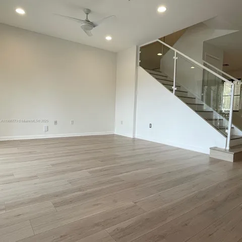 a view of room with wooden floor