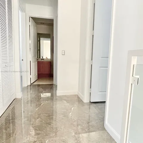 an entryway with a livingroom and a bathroom