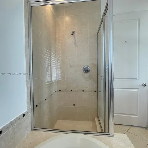 a bathroom with a glass shower door