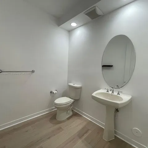 a bathroom with a sink toilet and a mirror