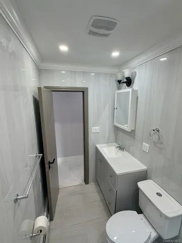 a view of a building stairs and a car parked in garage