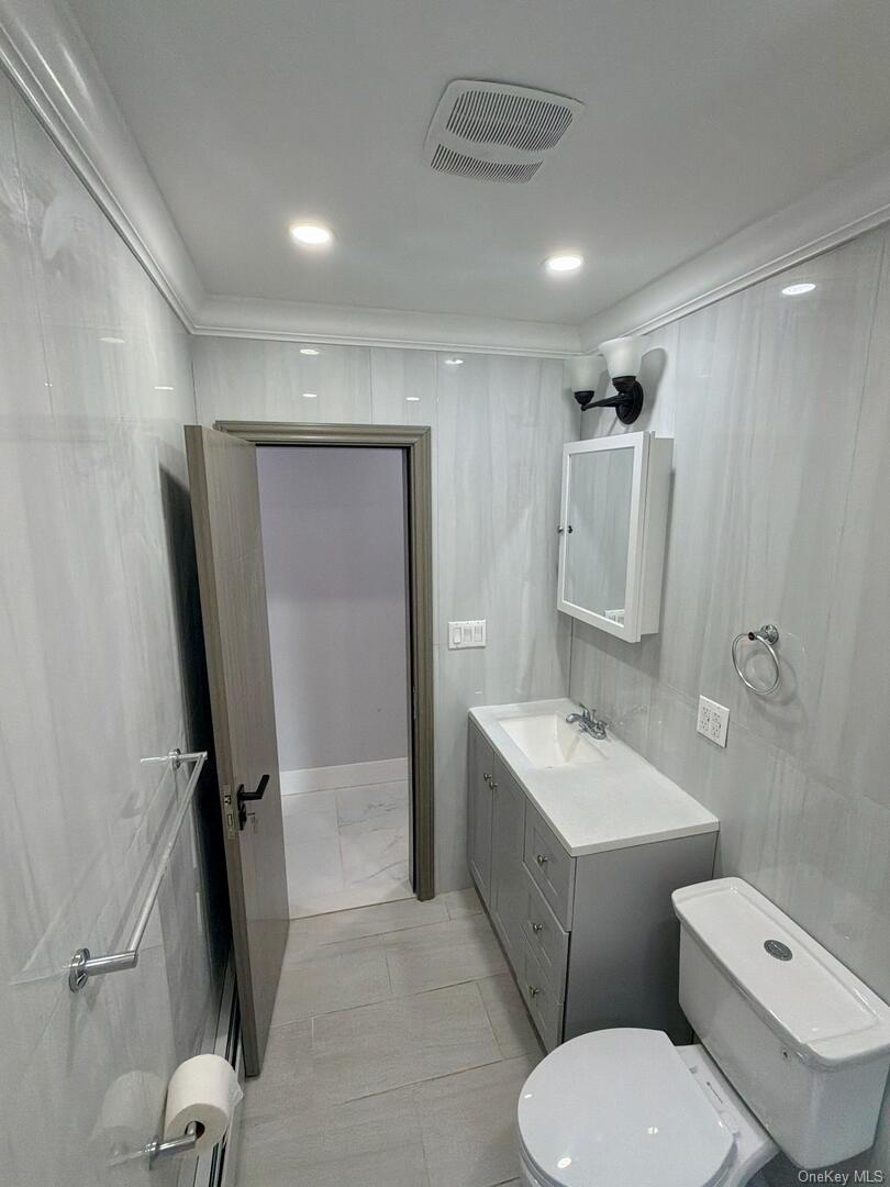 113-40 198th Street Queens, NY 11412 - Photo 12 of 20 a bathroom with a granite countertop toilet sink and mirror