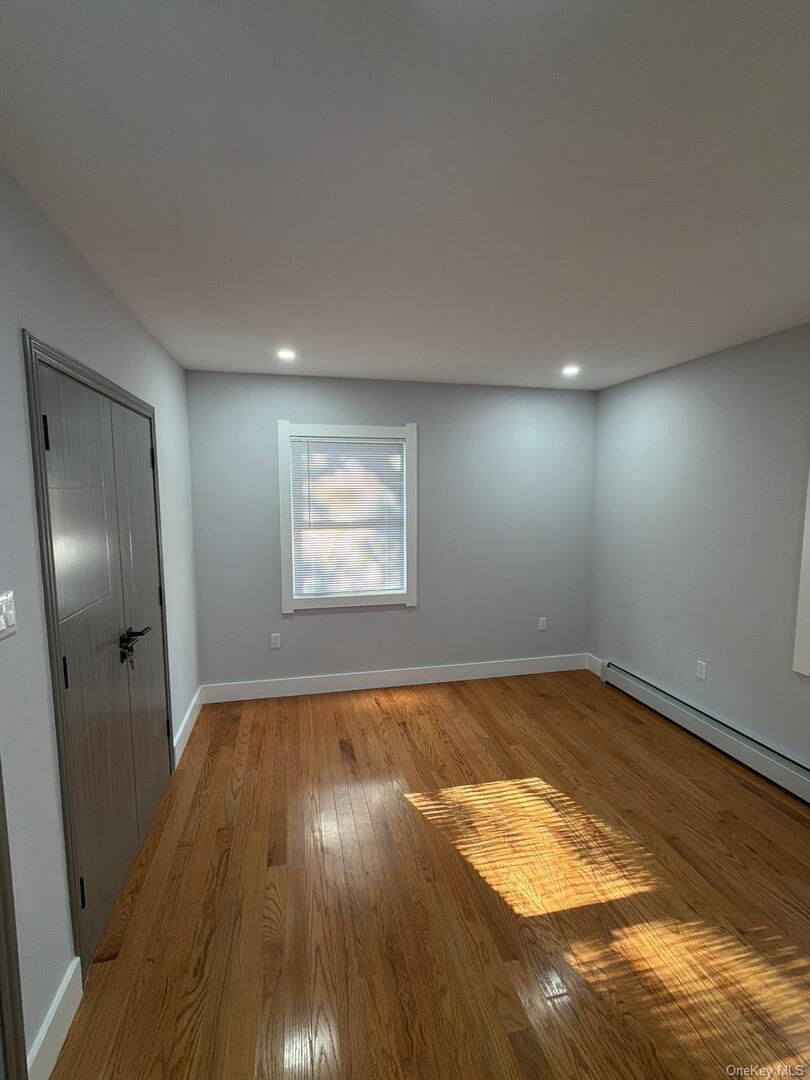 113-40 198th Street Queens, NY 11412 - Photo 14 of 20 a view of empty room with wooden floor
