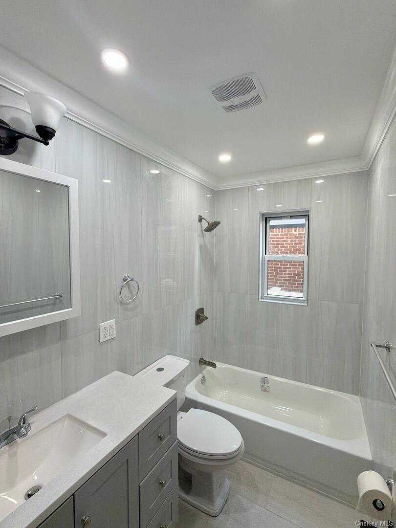113-40 198th Street Queens, NY 11412 - Photo 18 of 20 a bathroom with a double vanity sink toilet mirror and bathtub