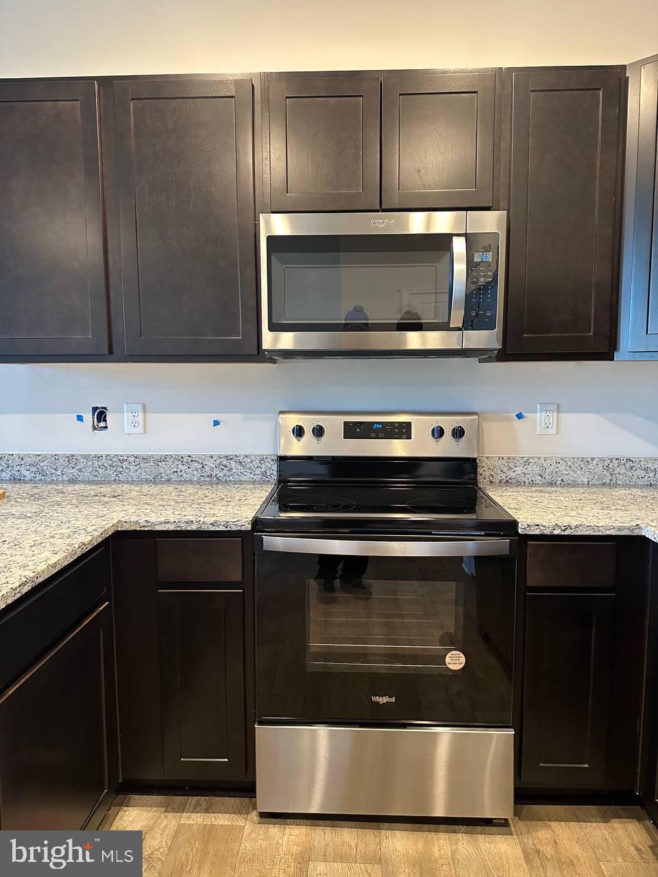 104 Baker Drive Luray, VA 22835 - Photo 3 of 16 a kitchen with granite countertop a stove and a microwave