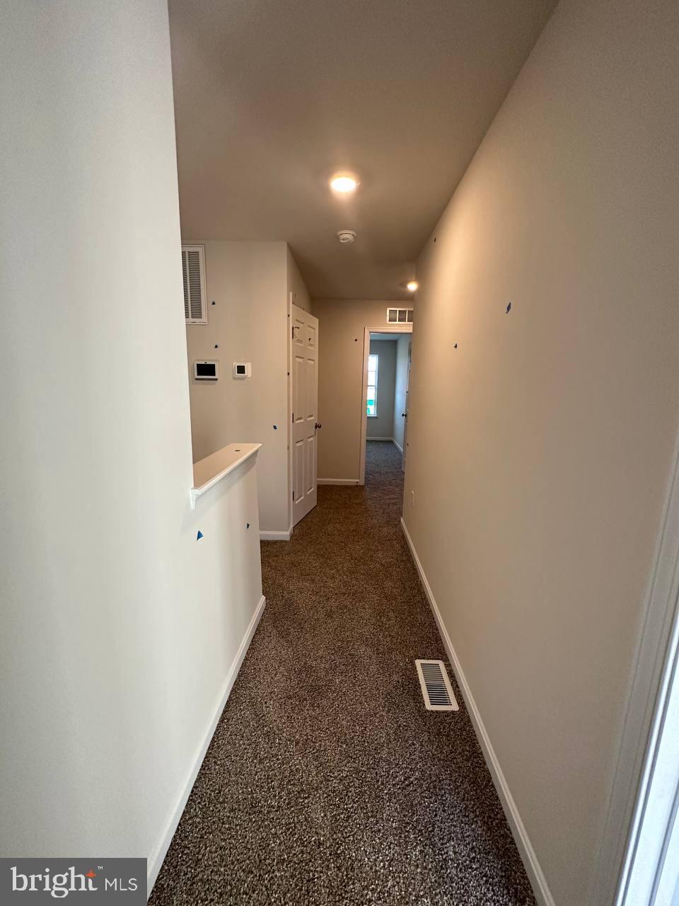 104 Baker Drive Luray, VA 22835 - Photo 9 of 16 a hallway with white doors wooden floor and front door