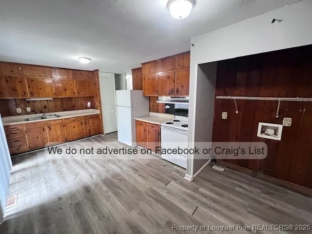 a large white kitchen with a stove and a refrigerator