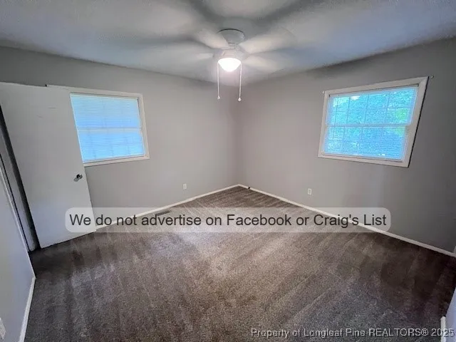 a view of a room with wooden floor and windows