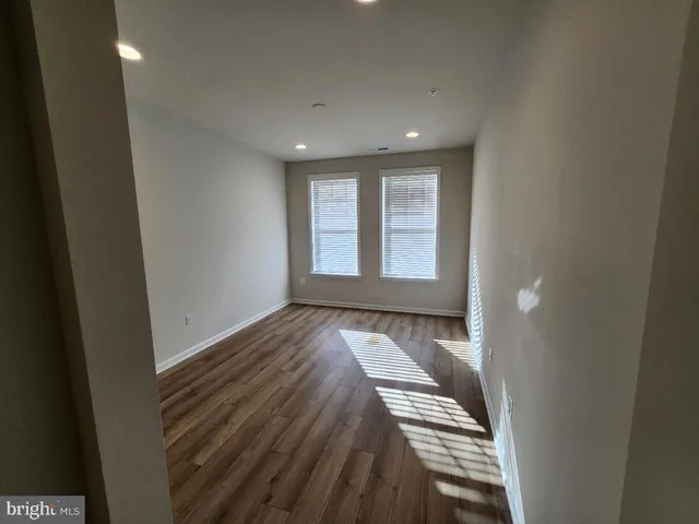 a view of an empty room and wooden floor