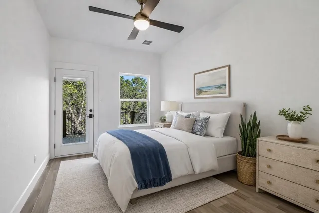 a bedroom with a large bed and a potted plant