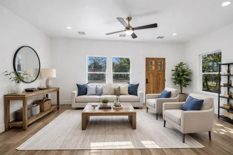 a living room with furniture a rug and a window