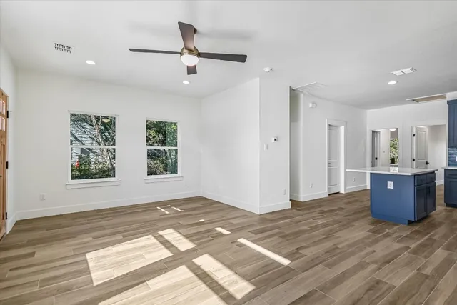 a view of a room with wooden floor and window