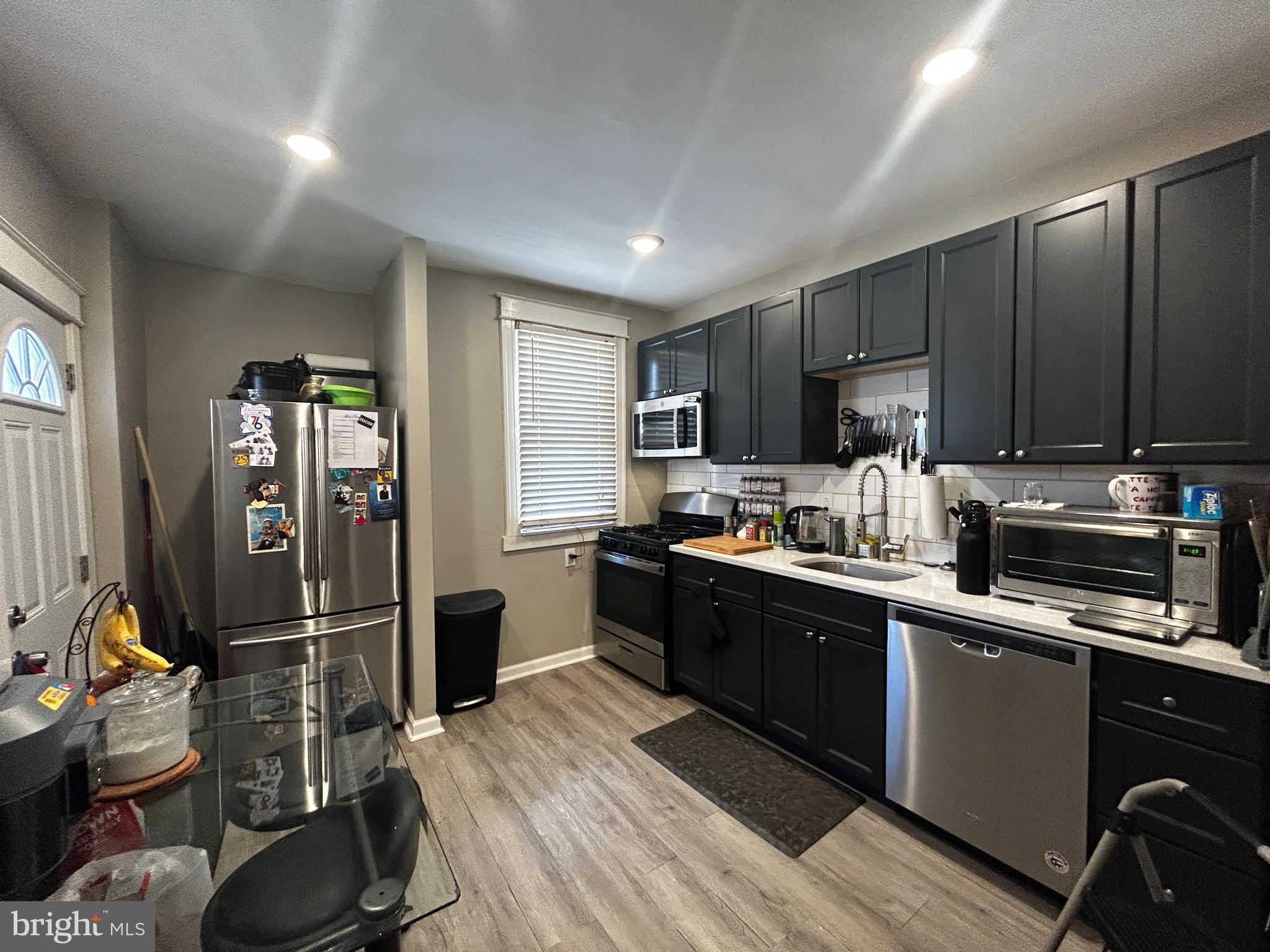 1117 Rosalie Street, Unit 1 Philadelphia, PA 19149 - Photo 14 of 29 a kitchen with stainless steel appliances granite countertop a refrigerator a sink dishwasher a stove top oven a refrigerator and cabinets