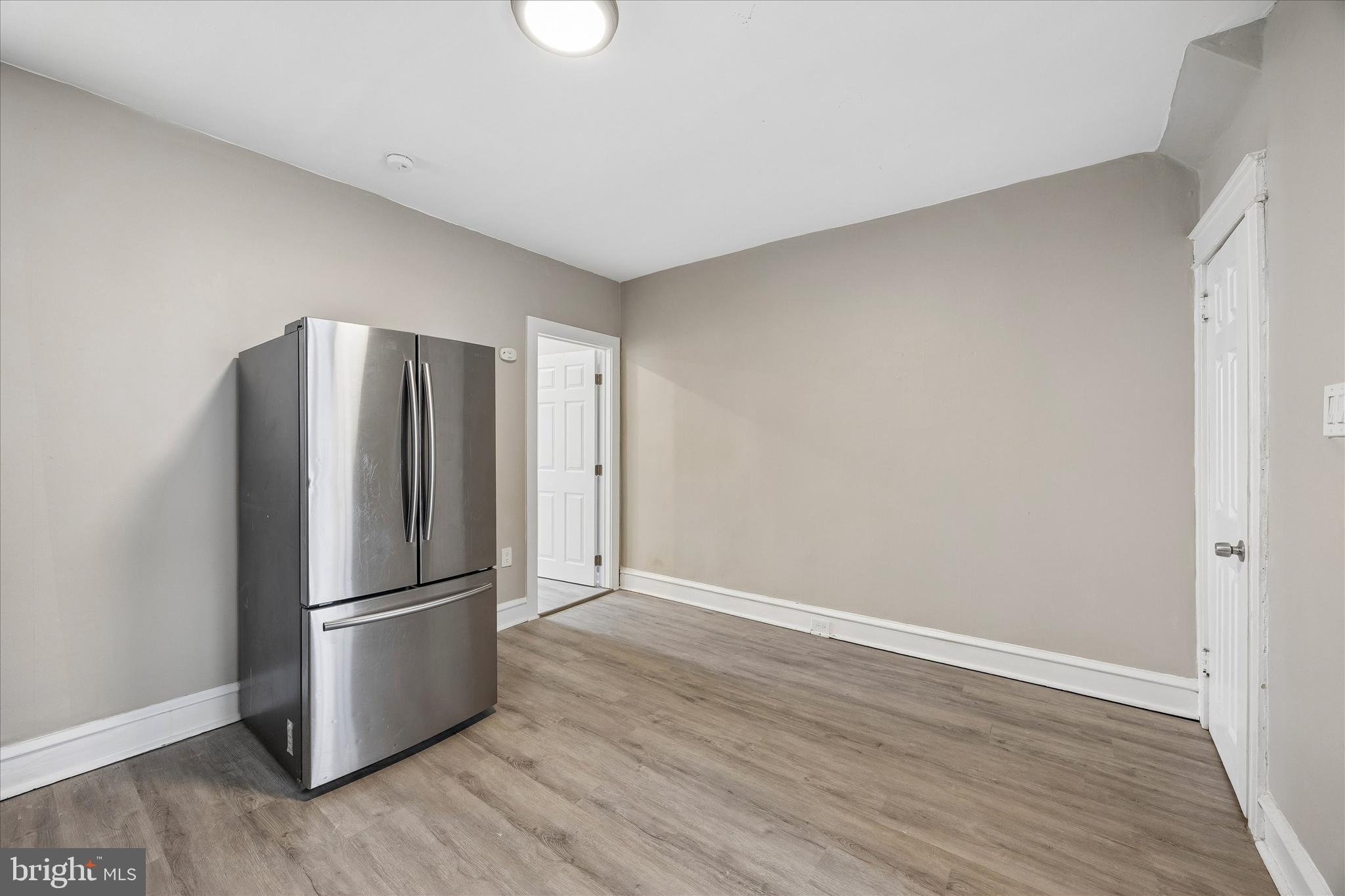 1117 Rosalie Street, Unit 1 Philadelphia, PA 19149 - Photo 14 of 30 a view of a kitchen with a refrigerator a stove top oven and wooden floor