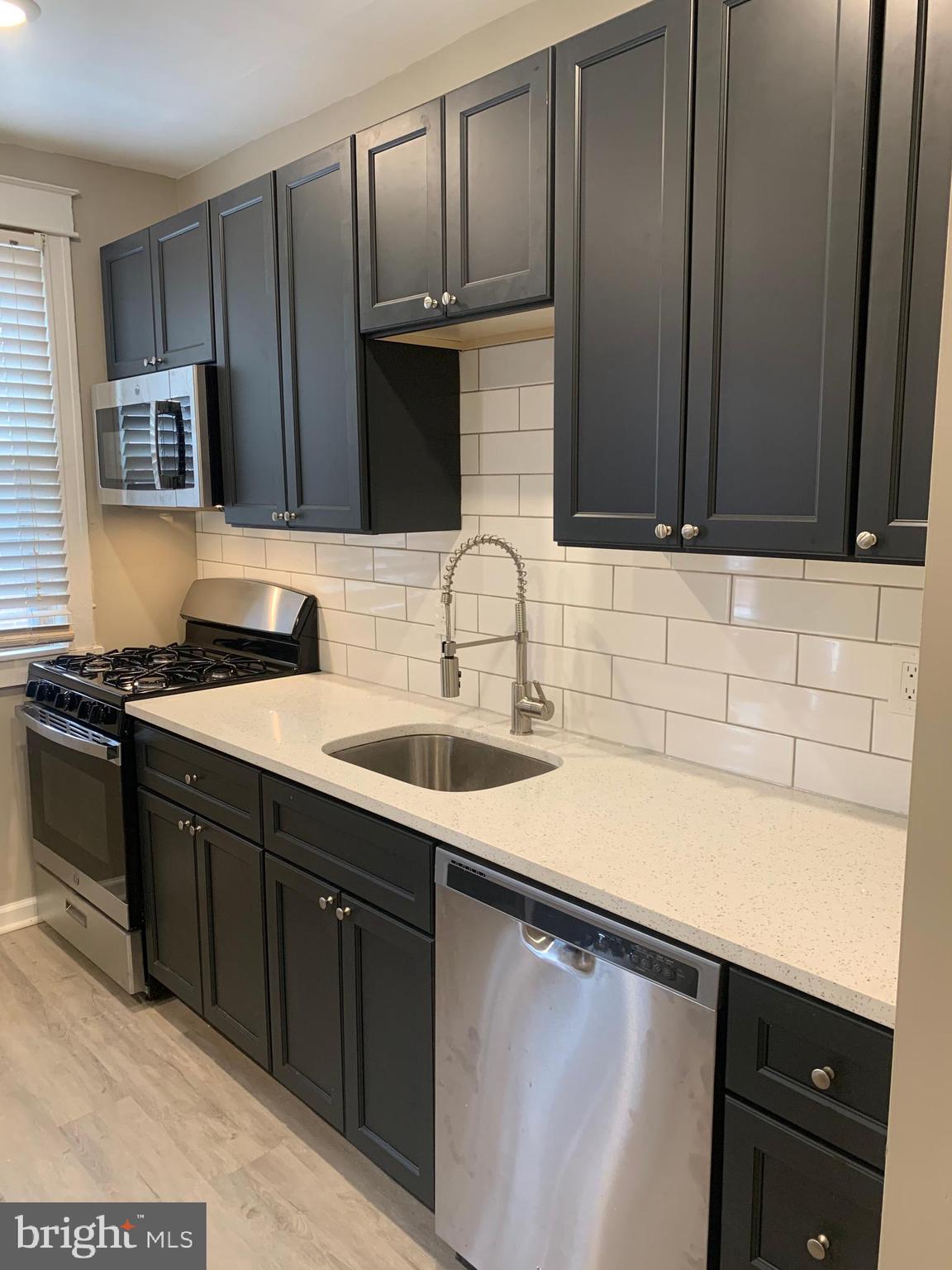 1117 Rosalie Street, Unit 1 Philadelphia, PA 19149 - Photo 15 of 29 a kitchen with a sink and cabinets