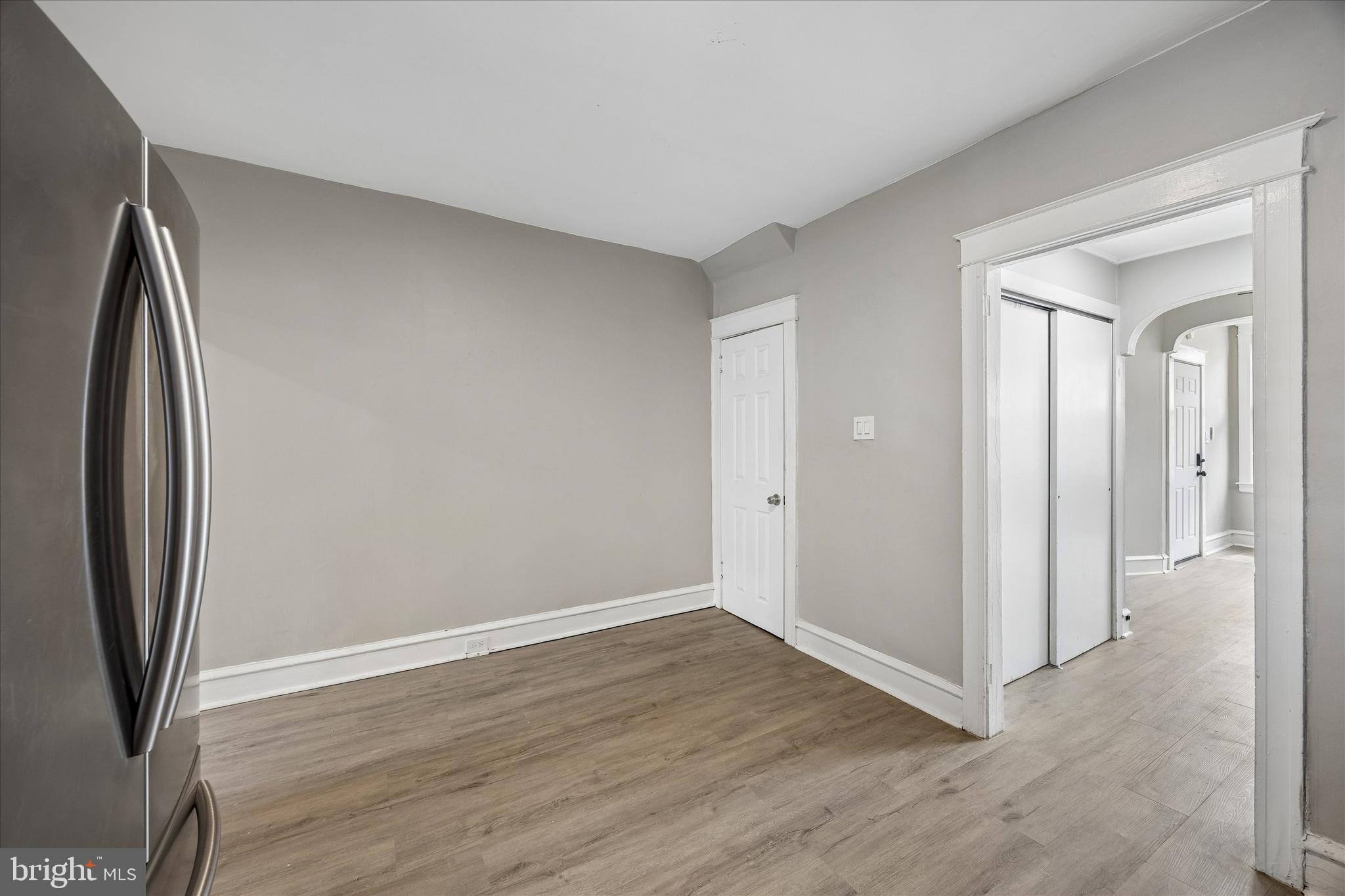1117 Rosalie Street, Unit 1 Philadelphia, PA 19149 - Photo 15 of 30 an empty room with wooden floor and a mirror