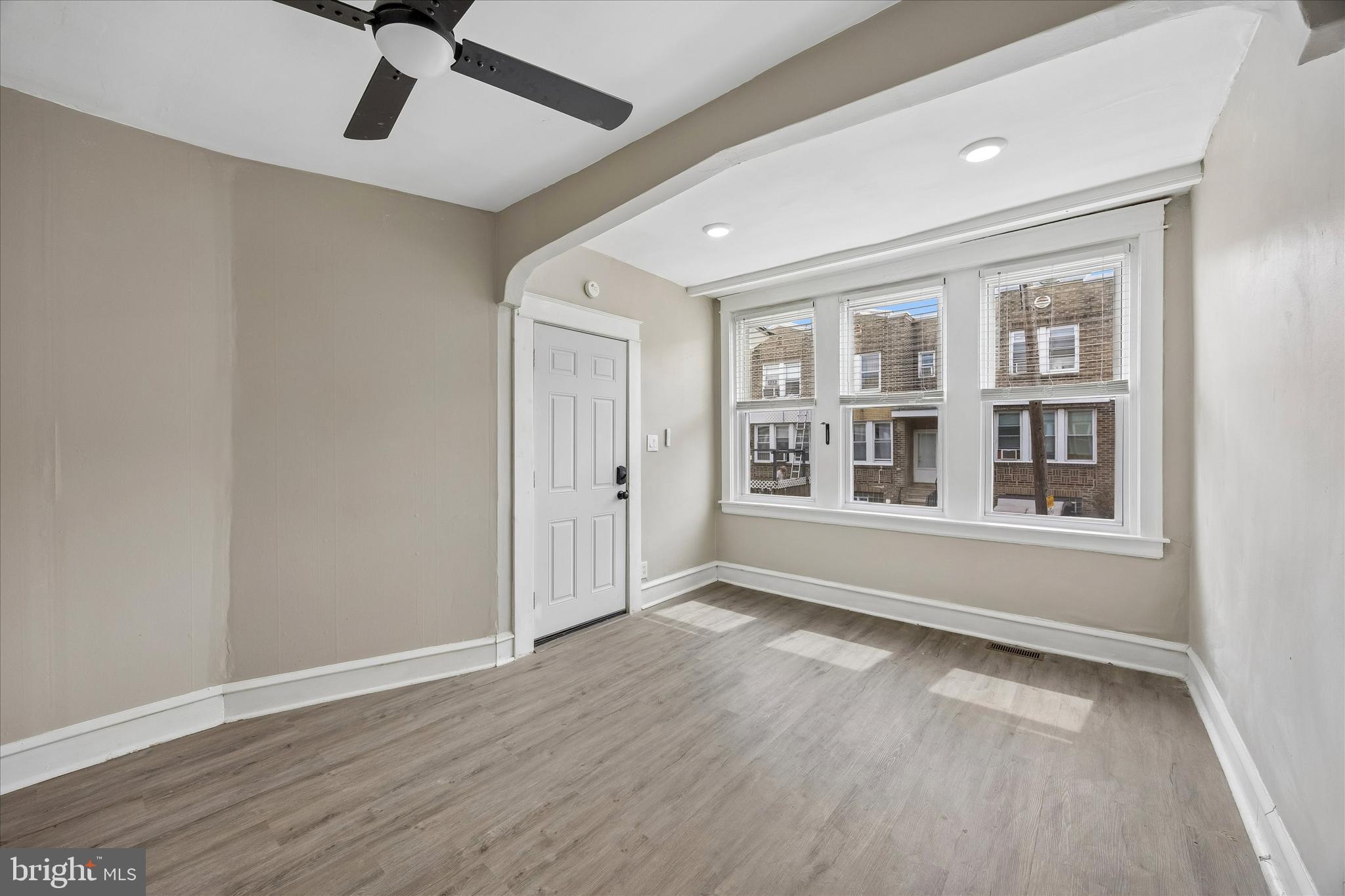 1117 Rosalie Street, Unit 1 Philadelphia, PA 19149 - Photo 3 of 30 a view of an empty room with a window and wooden floor