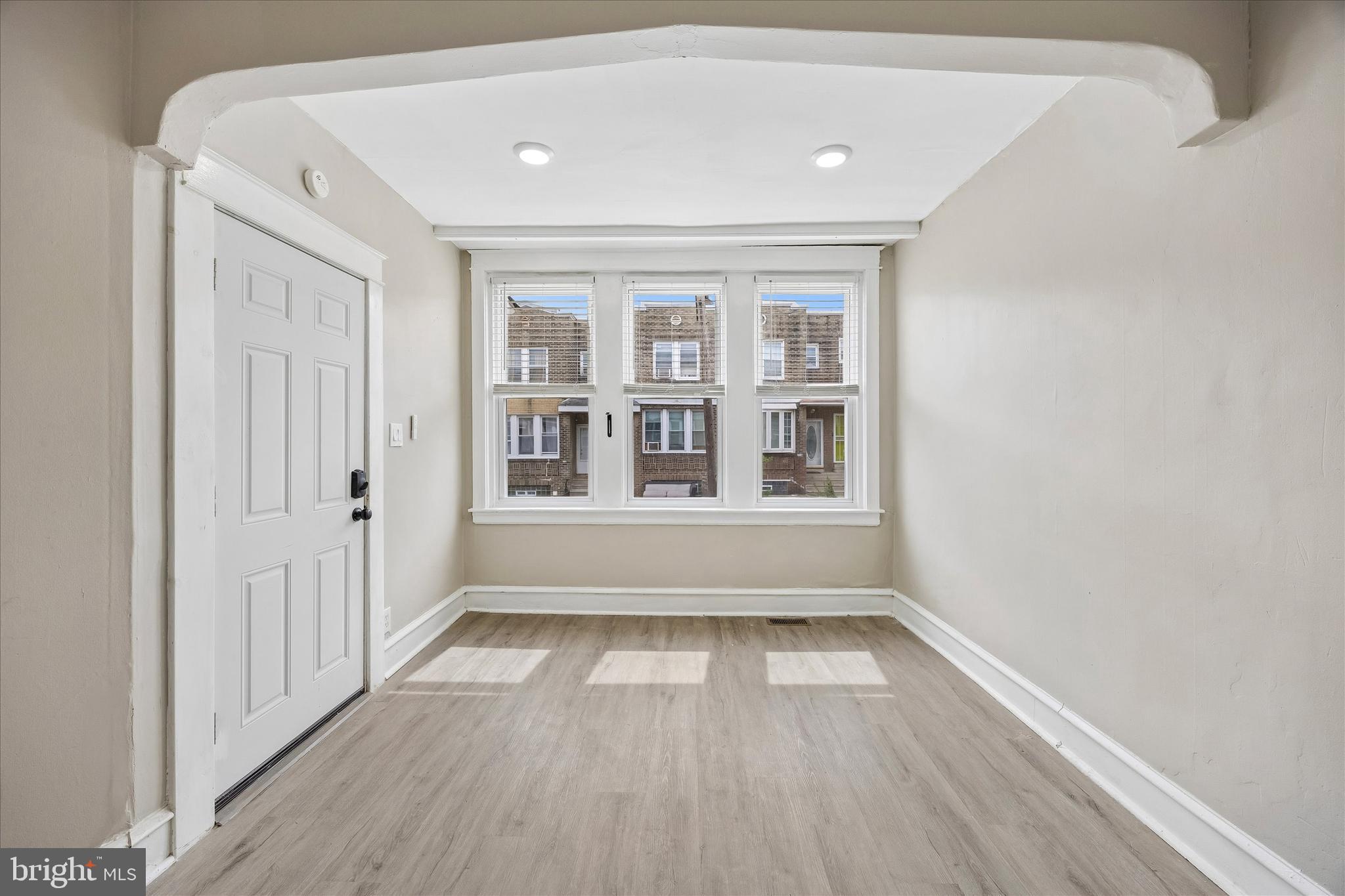 1117 Rosalie Street, Unit 1 Philadelphia, PA 19149 - Photo 5 of 30 a view of an empty room with wooden floor and a window