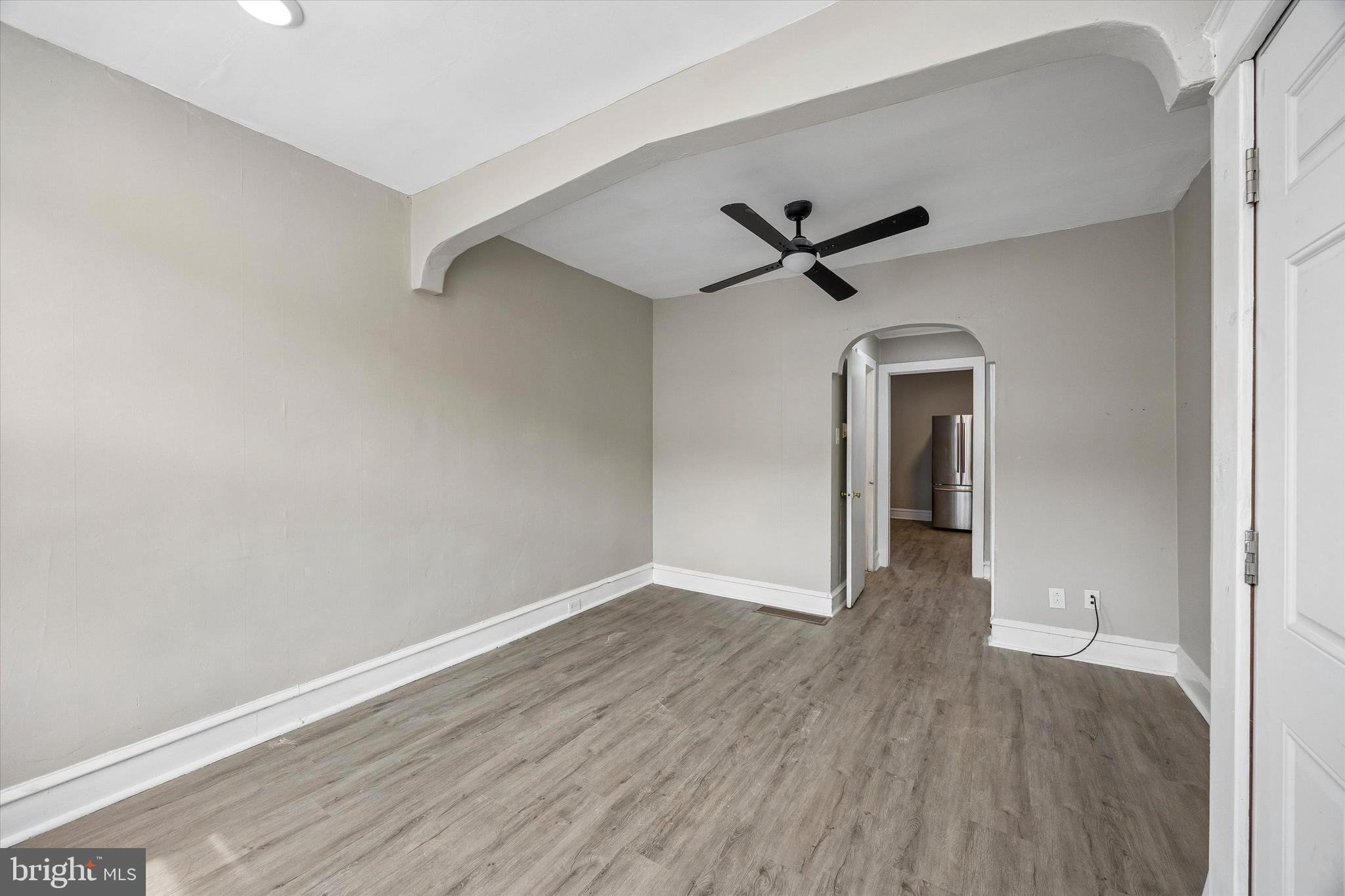 1117 Rosalie Street, Unit 1 Philadelphia, PA 19149 - Photo 7 of 30 an empty room with wooden floor and a ceiling fan