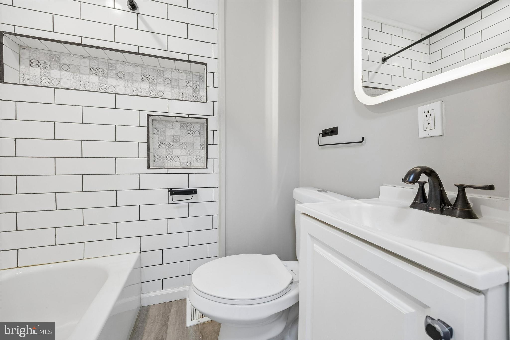 1117 Rosalie Street, Unit 1 Philadelphia, PA 19149 - Photo 8 of 30 a bathroom with a toilet a sink and mirror