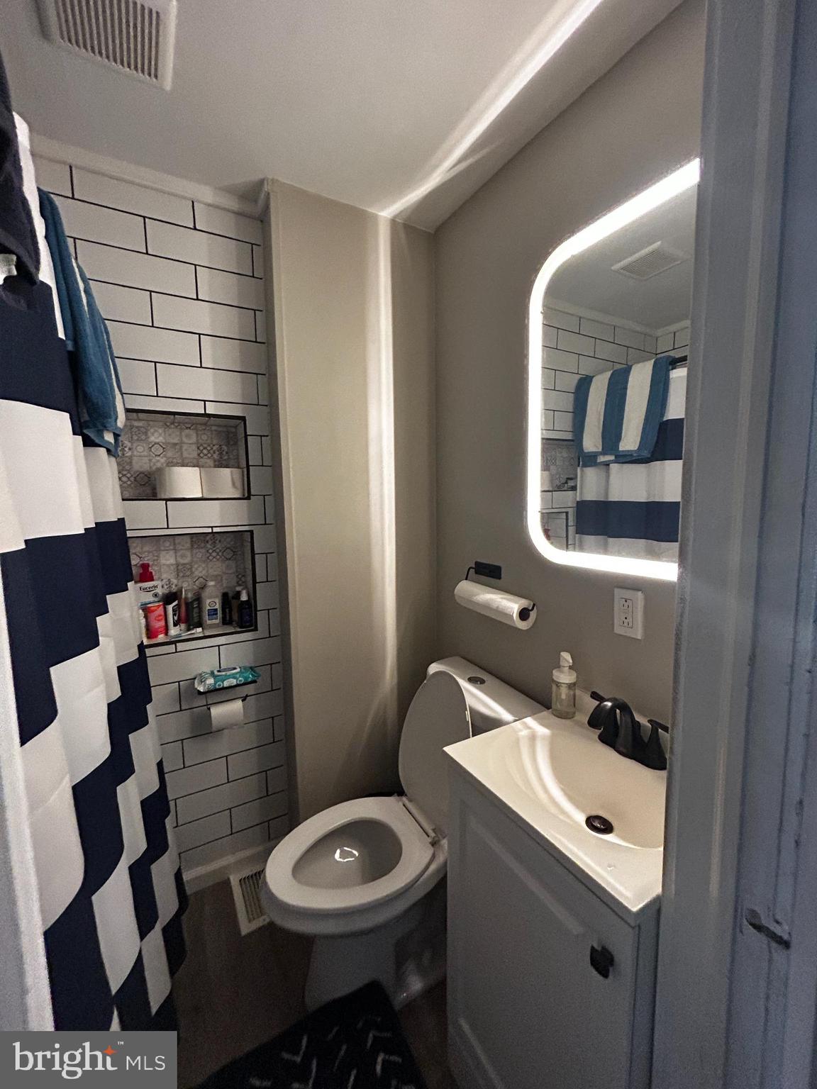 1117 Rosalie Street, Unit 1 Philadelphia, PA 19149 - Photo 10 of 29 a bathroom with a sink and a mirror